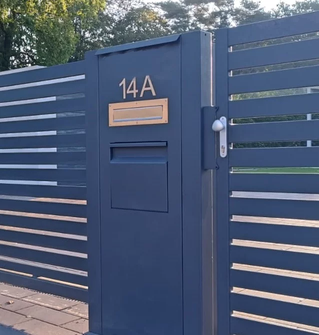 Metallsäule mit Briefkasten und Paketbox
